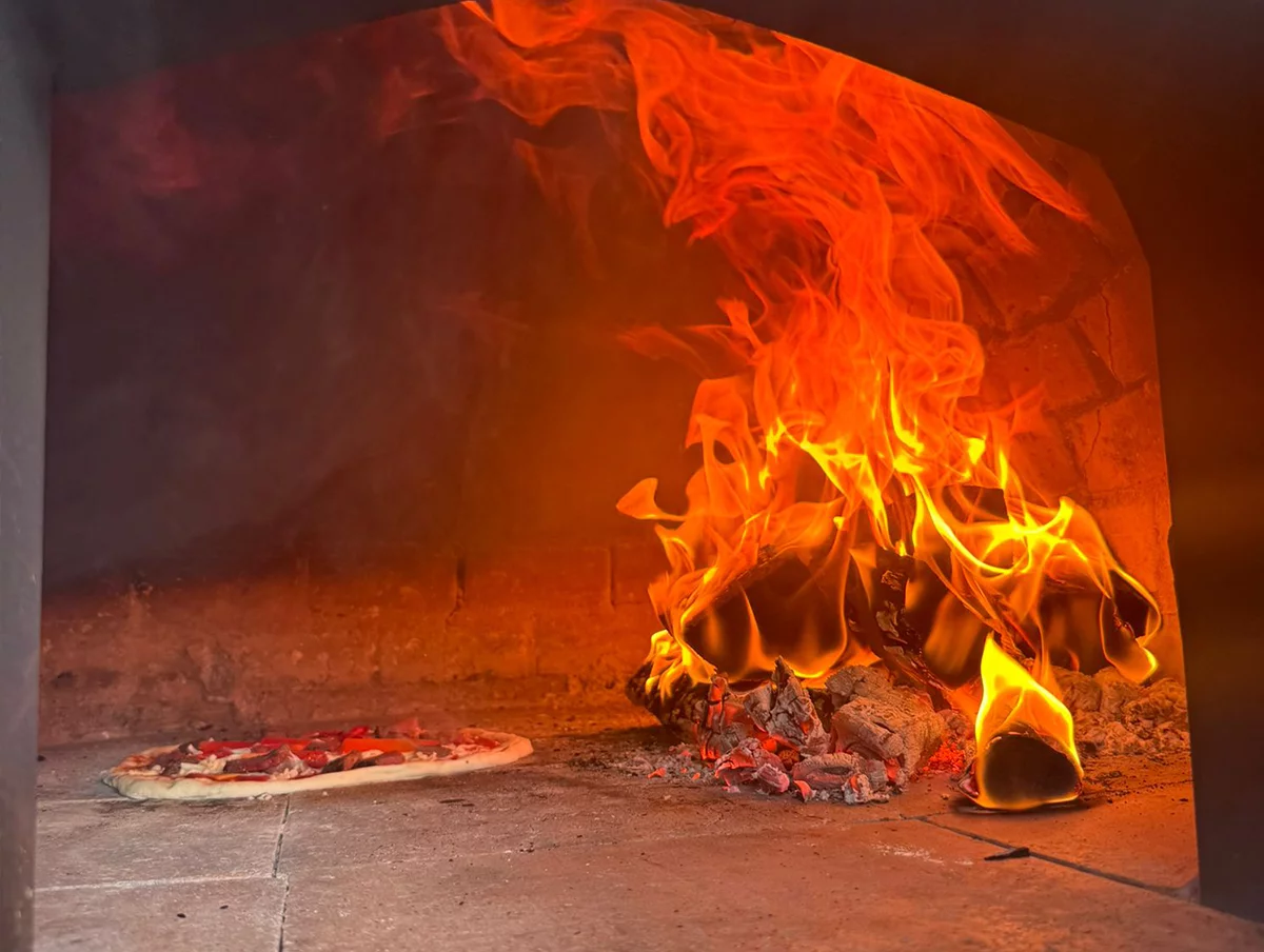 Pizza cooking in our wood-fired oven